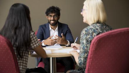 Student speaking with two careers and employability staff members