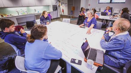 A photo of Dr Scott Rickard (pictured second from the right) in a group session. Image: Rafael Florez/CLT